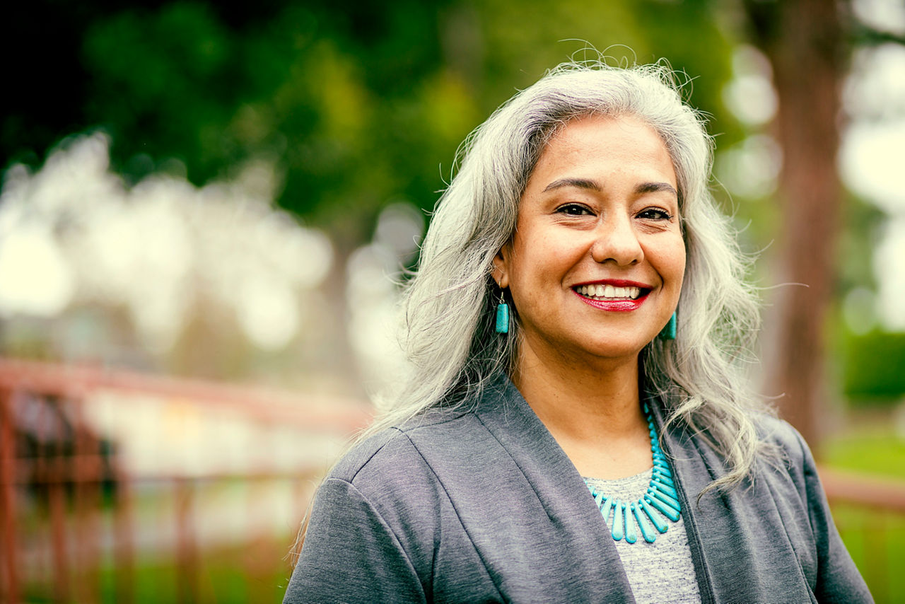 A portrait of a senior mexican female administrator on a campus