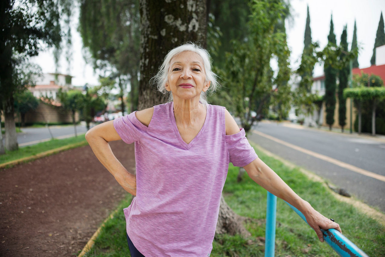 Portrait of an elderly white-haired Mexican woman while she exercises in a public park.