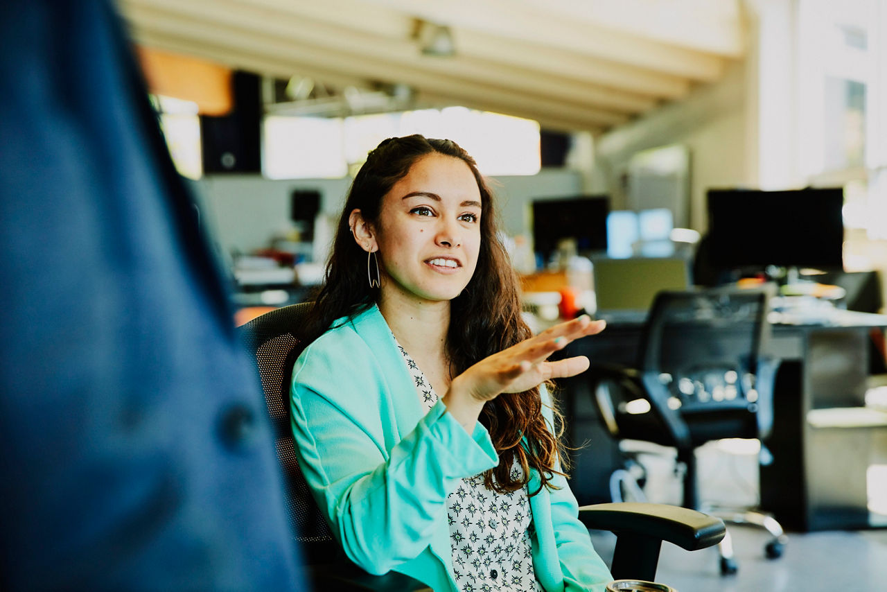 Businesswoman in discussion with coworkers in start up office