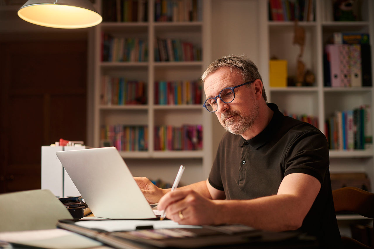 mature man working from home or sorting the home finances