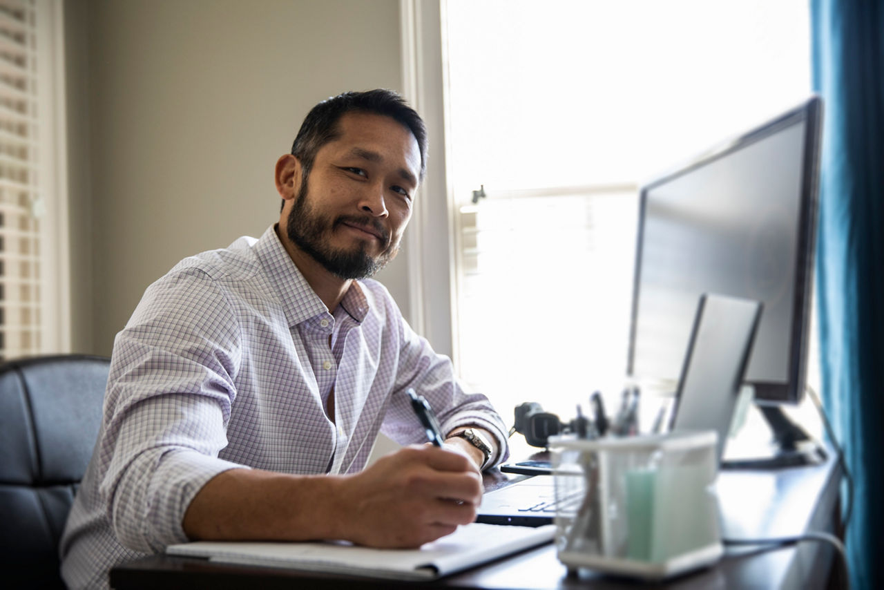 Man working on laptop in home office