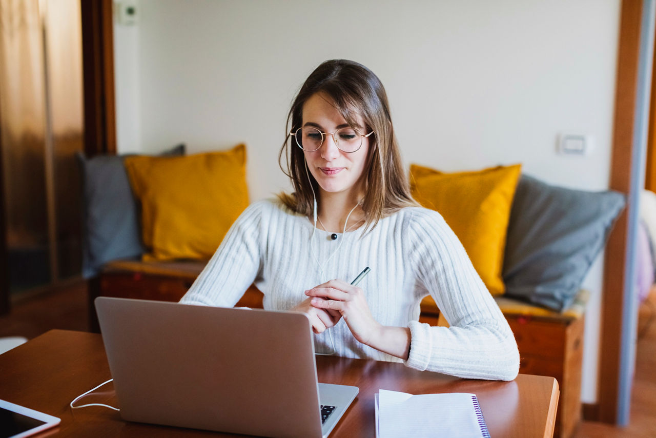 Student woman during E-Learning on laptop at home