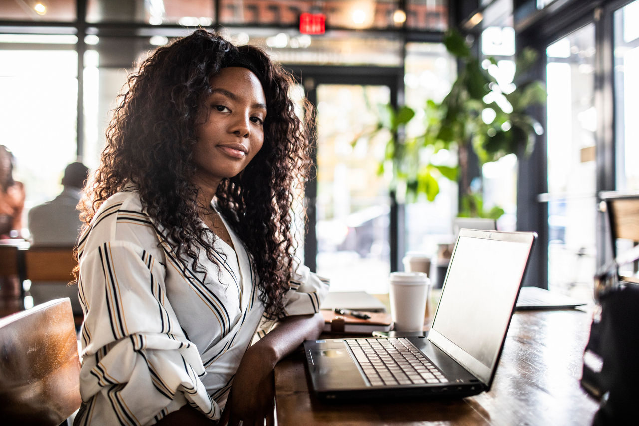 Portrait of young professional woman in coffee shop