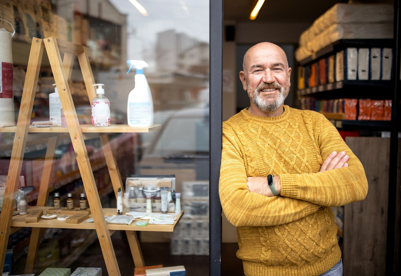 shop owner outside home goods store