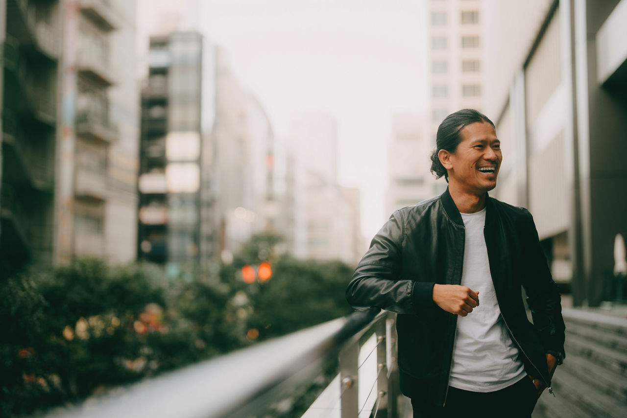 Portrait of Japanese man laughing in city, Tokyo