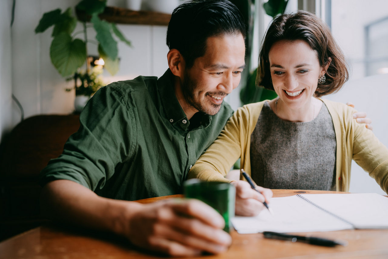 Cheerful couple planning and designing their future home