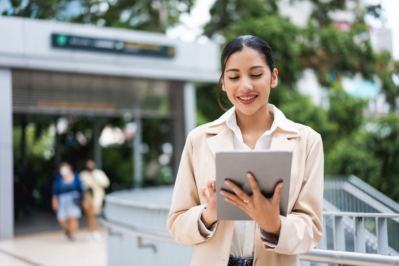 Asian businesswoman using a digital tablet working in the city