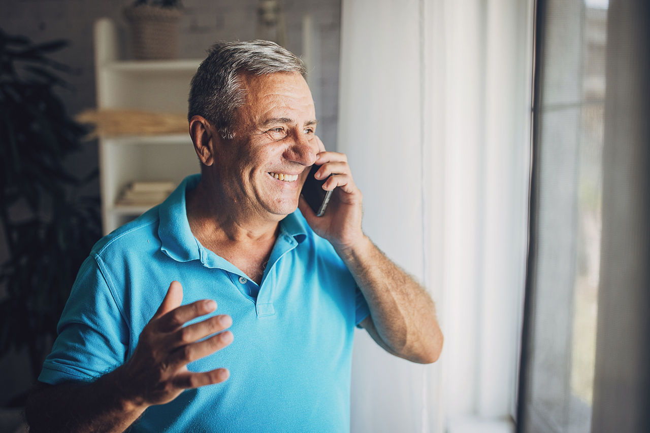 Senior active businessman using mobile phone