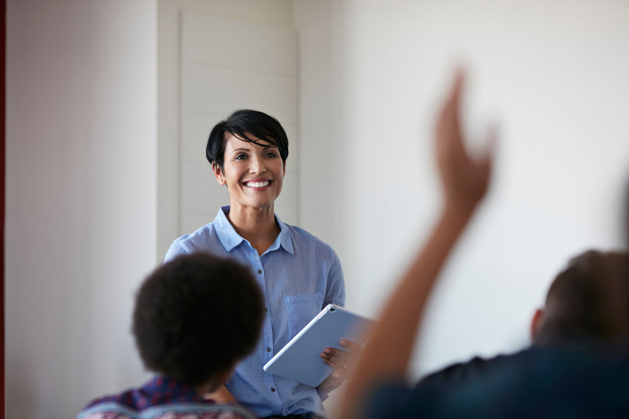 Teacher in front of student, raised hand