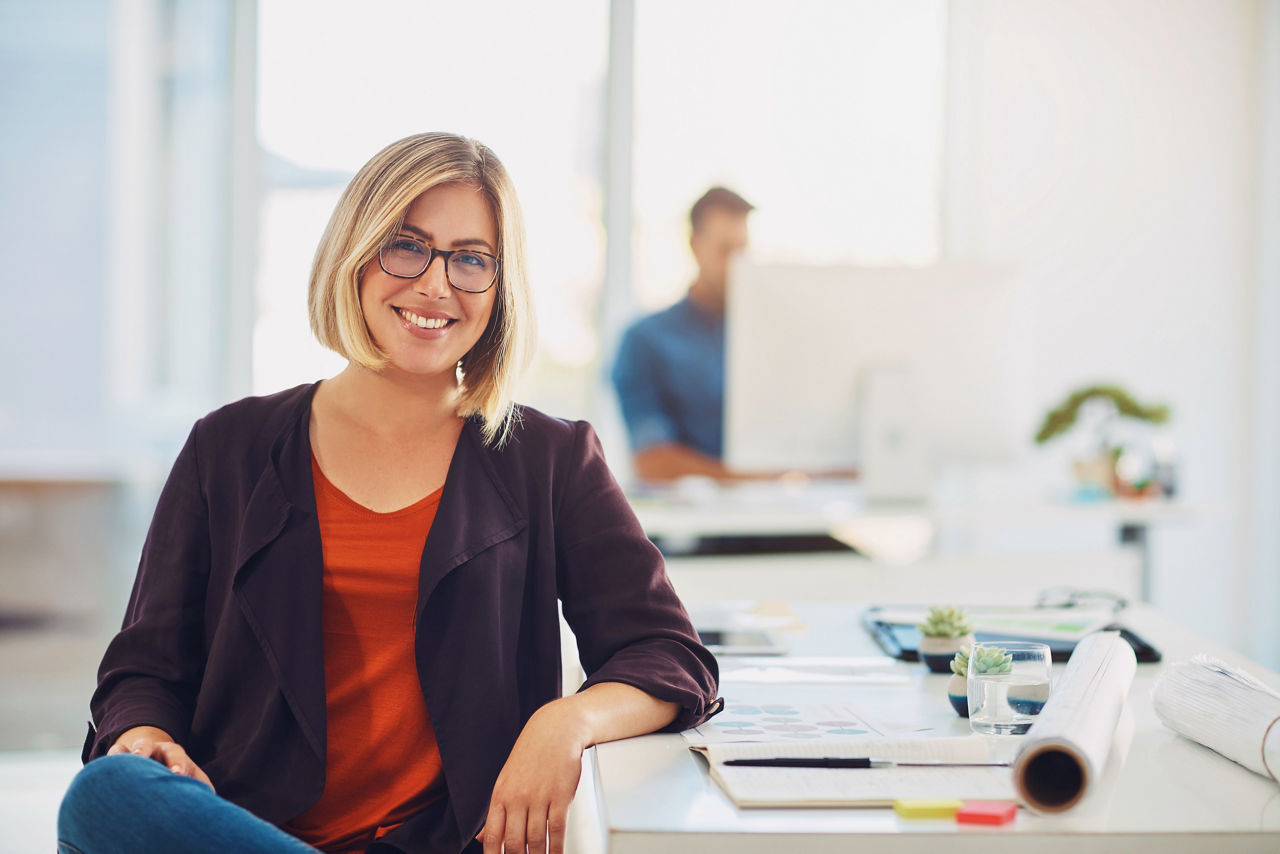 Portrait of a young woman working at her desk in a modern office