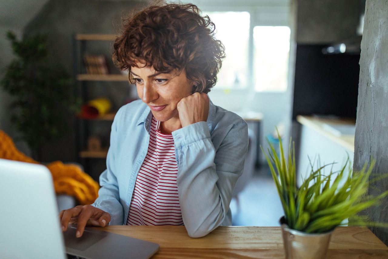 Photo of mature woman working at home