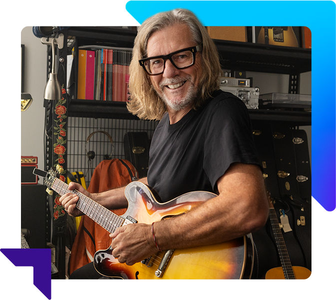 Smiling man playing a guitar
