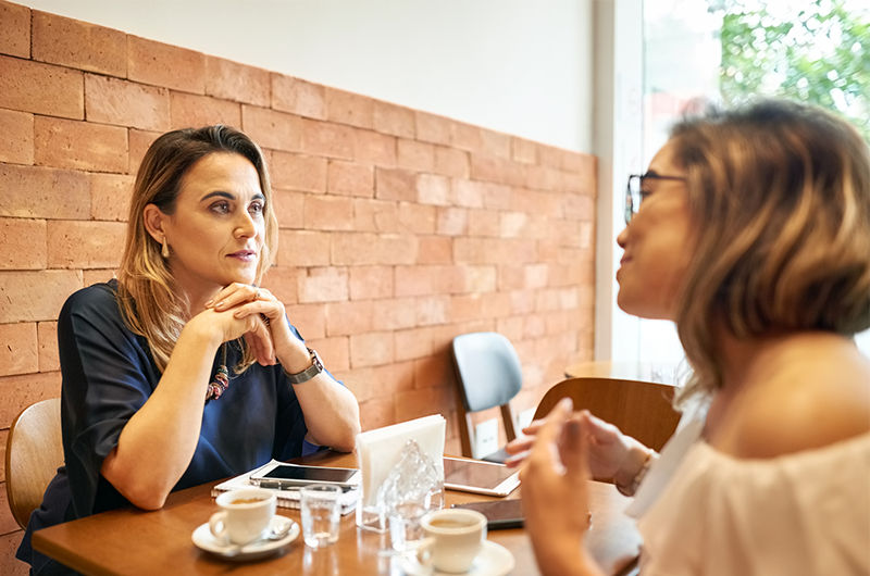 Women talking over coffee