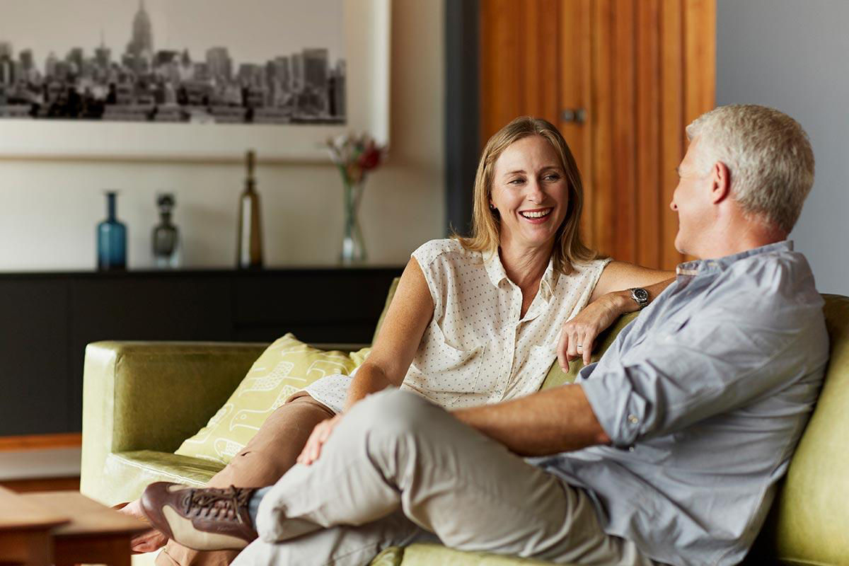 Man and woman sitting on couch